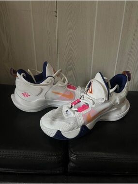 Nike White Basketball Shoes with Orange Swoosh and Pink Accents